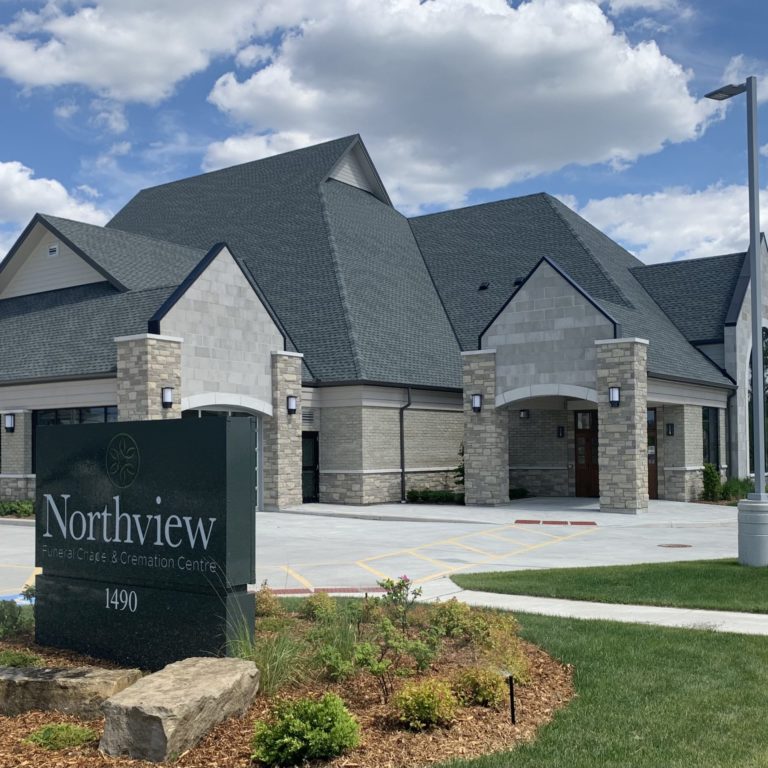 Exterior of a funeral home with brick walls and a Northview sign placed at the entrance.