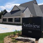 Exterior of a funeral home with bricks walls and the visible Northview sign at the entrance.
